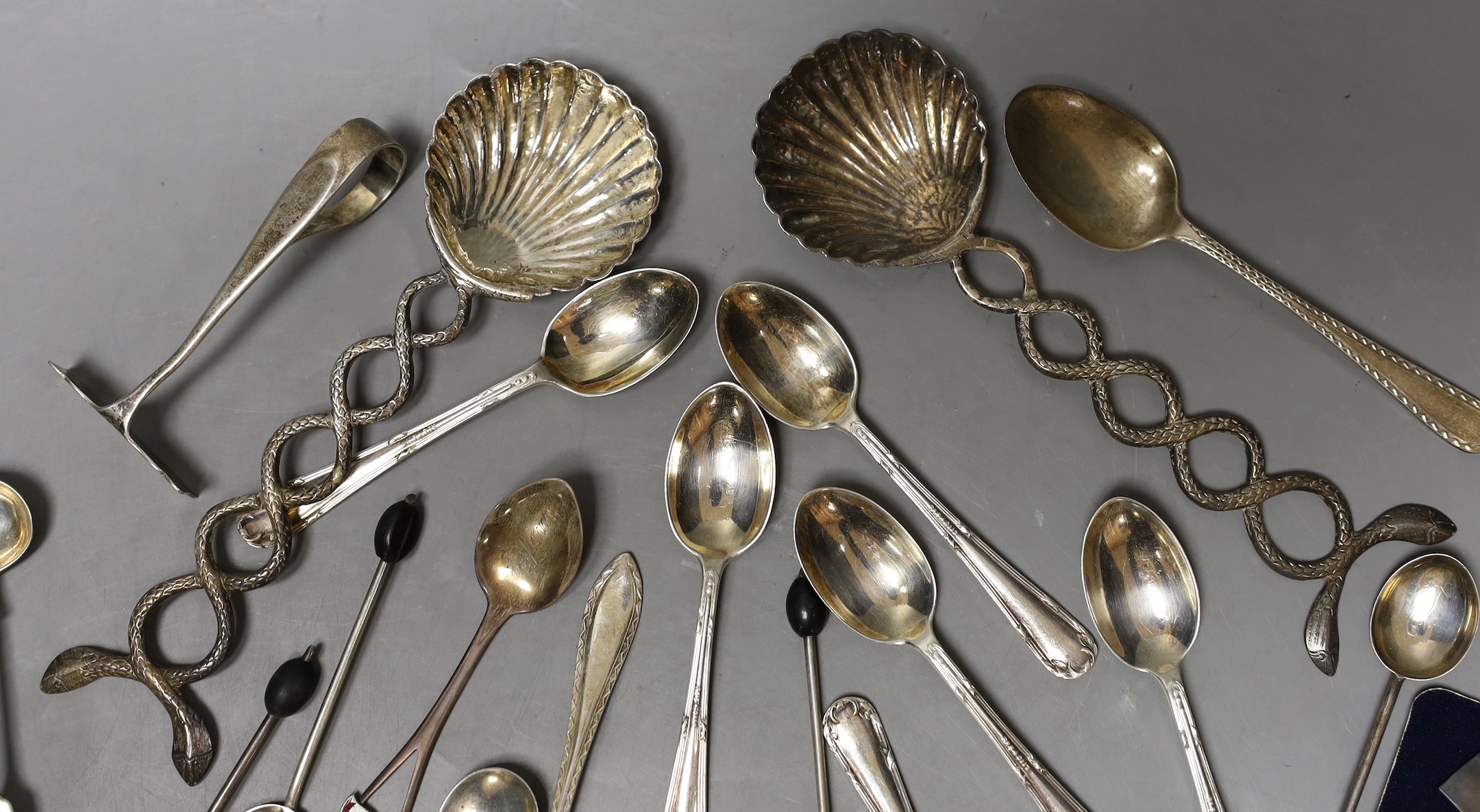 A small group of sundry flatware including a set of six George V silver teaspoons, Sheffield, 1923, a set of six silver bean end coffee spoons etc. and a pair of white metal shell bowl spoons.